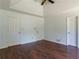 Bedroom with three doors, a ceiling fan and dark wood flooring at 101 Valleydale Dr, Stockbridge, GA 30281