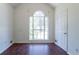 Bright room with dark wood floor, arched window providing ample natural light, and white door with gold handle at 101 Valleydale Dr, Stockbridge, GA 30281
