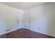 Neutral room featuring two white doors, wood flooring, and natural light at 101 Valleydale Dr, Stockbridge, GA 30281