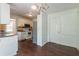 Dining area with wood-look floors open to a kitchen with white cabinets and stainless fridge at 101 Valleydale Dr, Stockbridge, GA 30281