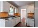 Bright kitchen featuring a window, white cabinets, and wood-look flooring at 101 Valleydale Dr, Stockbridge, GA 30281