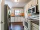 Functional kitchen with stainless steel refrigerator, white cabinets, and wood-look floors at 101 Valleydale Dr, Stockbridge, GA 30281