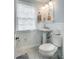 Cozy bathroom with beadboard walls, mosaic tile flooring, and a pedestal sink at 1157 Hancock Ne Dr, Atlanta, GA 30306