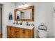 Bathroom with double sinks, wood-framed mirror, and tiled floors at 1157 Hancock Ne Dr, Atlanta, GA 30306