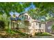 Exterior view of home with a balcony, brick chimney, stone foundation, and landscaped backyard at 1157 Hancock Ne Dr, Atlanta, GA 30306