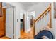 Hallway featuring hardwood floors, white trim, and a view into an adjacent living room at 1157 Hancock Ne Dr, Atlanta, GA 30306