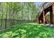 Fenced yard features a grassy lawn, complemented by the shade from the deck above at 125 Stoney Ridge Dr, Alpharetta, GA 30022