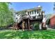 Exterior elevation showcasing a sprawling two-story home with a multi-tiered deck, perfect for outdoor living at 125 Stoney Ridge Dr, Alpharetta, GA 30022