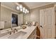 Bathroom vanity with double sinks and a large mirror illuminated by globe lights at 125 Stoney Ridge Dr, Alpharetta, GA 30022