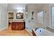 This bathroom features an elegant soaking tub, an all glass shower, and granite countertops at 125 Stoney Ridge Dr, Alpharetta, GA 30022
