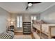 Well-lit bedroom with wood floors featuring a cozy bunk bed and bright light from shuttered windows at 125 Stoney Ridge Dr, Alpharetta, GA 30022