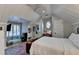 A well-lit bedroom features a bed, built-in desk and shelves under a vaulted ceiling and clerestory window at 125 Stoney Ridge Dr, Alpharetta, GA 30022