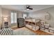 Bright bedroom featuring a cozy bunk bed, neutral walls, ceiling fan, and natural light from shuttered windows at 125 Stoney Ridge Dr, Alpharetta, GA 30022