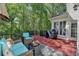 Relaxing outdoor deck with seating, a grill, and a view of the surrounding greenery at 125 Stoney Ridge Dr, Alpharetta, GA 30022
