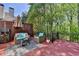 Outdoor deck with comfortable seating, a table, and a view of the surrounding greenery at 125 Stoney Ridge Dr, Alpharetta, GA 30022