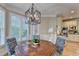 Dining room with crown molding, plantation shutters, and modern lighting at 125 Stoney Ridge Dr, Alpharetta, GA 30022