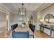 Open-concept dining room with stylish light fixture and well-appointed furnishings at 125 Stoney Ridge Dr, Alpharetta, GA 30022