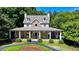 Charming two-story home with a covered porch, stone accents, and well-manicured lawn at 125 Stoney Ridge Dr, Alpharetta, GA 30022