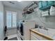 Spacious laundry room with a modern washer and dryer, utility sink, and ample storage shelving at 125 Stoney Ridge Dr, Alpharetta, GA 30022