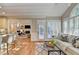 Open floor plan with a kitchen bar that flows into a bright living room with shuttered windows at 125 Stoney Ridge Dr, Alpharetta, GA 30022
