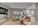 Cozy living room featuring neutral tones, large windows, comfortable seating, and a TV for entertainment at 125 Stoney Ridge Dr, Alpharetta, GA 30022