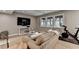 Comfortable living room featuring neutral tones, large windows, and a TV for entertainment at 125 Stoney Ridge Dr, Alpharetta, GA 30022