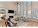 Bright living room with two-story windows, fireplace, and comfortable seating area at 125 Stoney Ridge Dr, Alpharetta, GA 30022