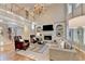Bright living room featuring hardwood floors, a fireplace, and a beautiful chandelier at 125 Stoney Ridge Dr, Alpharetta, GA 30022