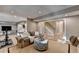 Bright living room with a staircase, comfortable seating, and a large window providing natural light at 125 Stoney Ridge Dr, Alpharetta, GA 30022