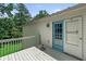 Back deck features a painted wood floor, white railing, and a door leading into the home at 1303 Flat Shoals Rd, Atlanta, GA 30349