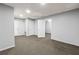 Spacious basement features carpeted floors, neutral walls, and multiple access doors, with recessed lighting at 1303 Flat Shoals Rd, Atlanta, GA 30349