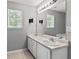 Bathroom with dual sinks, large mirror, and a window for natural light at 1303 Flat Shoals Rd, Atlanta, GA 30349