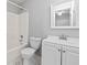 A bathroom featuring a white vanity, toilet, and bathtub with shower, all in a clean, neutral color scheme at 1303 Flat Shoals Rd, Atlanta, GA 30349