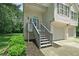 Inviting front entrance with gray stairs and trim, complemented by fresh landscaping and a well-maintained lawn at 1303 Flat Shoals Rd, Atlanta, GA 30349
