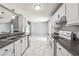 Bright kitchen featuring white cabinets, modern appliances, and marble-look flooring at 1303 Flat Shoals Rd, Atlanta, GA 30349