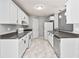 Galley kitchen with white cabinets, stainless appliances, and gray countertop at 1303 Flat Shoals Rd, Atlanta, GA 30349