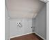 Compact laundry room includes hookups, shelving for storage, and wood-look flooring at 1303 Flat Shoals Rd, Atlanta, GA 30349