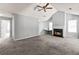 Spacious living room with neutral paint, fireplace, vaulted ceiling, ceiling fan, and ample natural light at 1303 Flat Shoals Rd, Atlanta, GA 30349