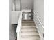 A view of the staircase with gray carpet leading to the upper level at 1303 Flat Shoals Rd, Atlanta, GA 30349