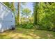 Spacious backyard with mature trees and lush greenery offering privacy and a tranquil outdoor space at 1328 Lockhaven Sw Cir, Atlanta, GA 30311