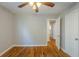 Bedroom with hardwood floors, ceiling fan, and white doors, offering a simple design at 1328 Lockhaven Sw Cir, Atlanta, GA 30311