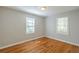 Bedroom featuring hardwood floors, fresh paint, and natural light from two windows at 1328 Lockhaven Sw Cir, Atlanta, GA 30311