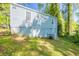 View of the side of a home with light blue siding and a green, grassy yard at 1328 Lockhaven Sw Cir, Atlanta, GA 30311