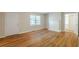 Spacious living room featuring gleaming hardwood floors, a fireplace, and ample natural light from a large window at 1328 Lockhaven Sw Cir, Atlanta, GA 30311
