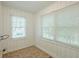 Bright room with painted paneling, tiled floor, and two windows for natural light at 1328 Lockhaven Sw Cir, Atlanta, GA 30311