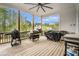 Covered back porch with ceiling fan, wood decking, and multiple grills for outdoor cooking at 3039 Malbec Vly, Acworth, GA 30101