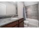 This well-appointed bathroom features a stylish shower, vanity with granite counters, and plenty of natural light at 3039 Malbec Vly, Acworth, GA 30101