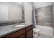 Bathroom vanity with dark wood cabinets and a tub and shower combo at 3039 Malbec Vly, Acworth, GA 30101
