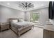 A well-lit bedroom showcases a wooden bed frame, window, and neutral decor, creating a relaxing ambiance at 3039 Malbec Vly, Acworth, GA 30101