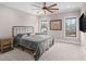 This bright bedroom features a black metal bed frame and two large windows with neighborhood views at 3039 Malbec Vly, Acworth, GA 30101